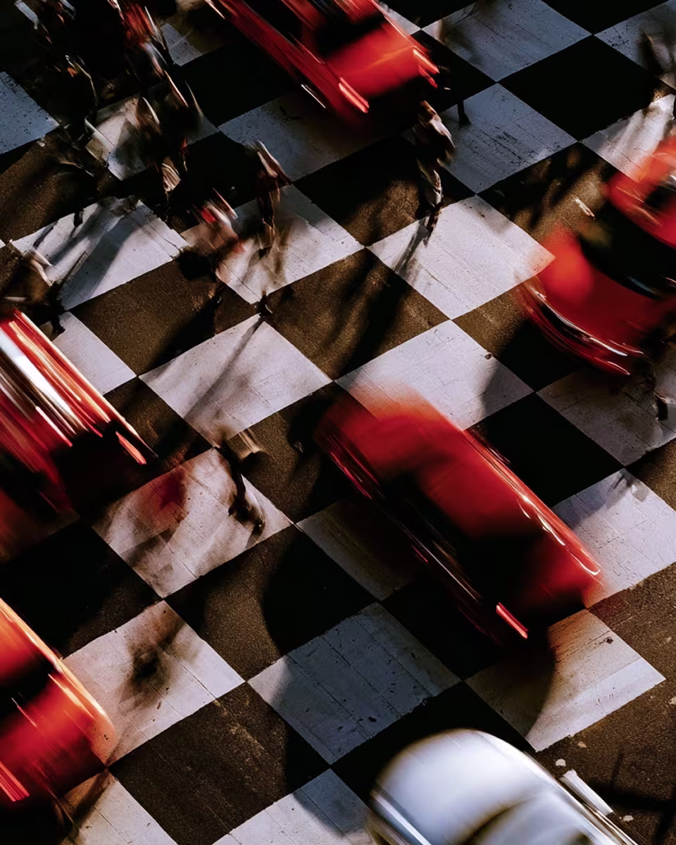 Red taxis crossing a checkered city intersection